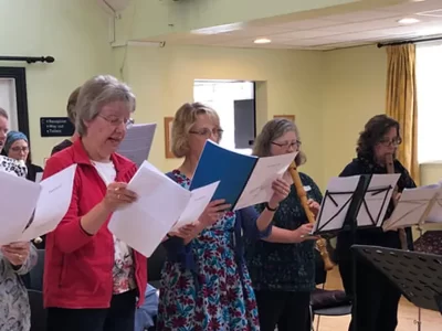 Ladies singing woth sheet music
