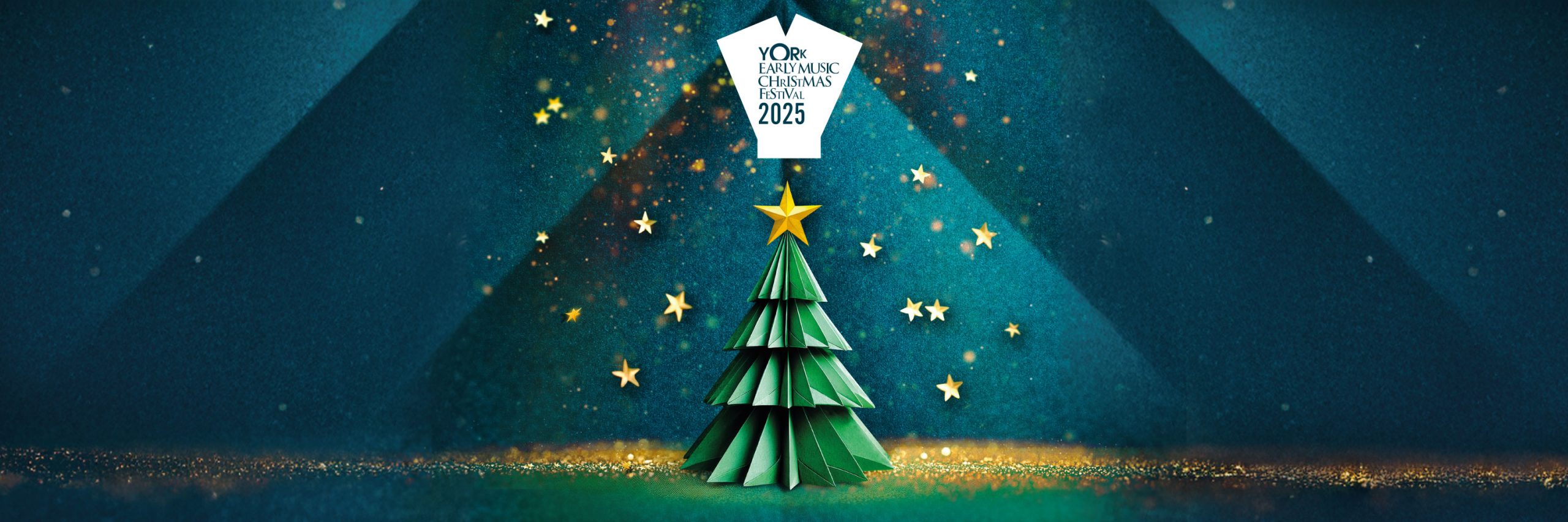 An origami christmas tree against a background of folded teal paper and falling gold stars and glitter